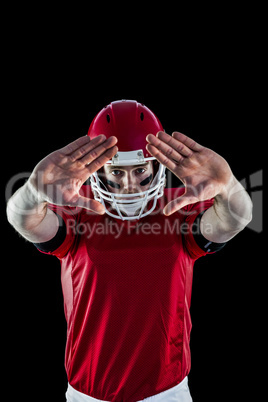 Portrait of american football player protecting himself