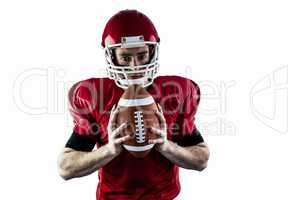 Portrait of focused american football player holding football