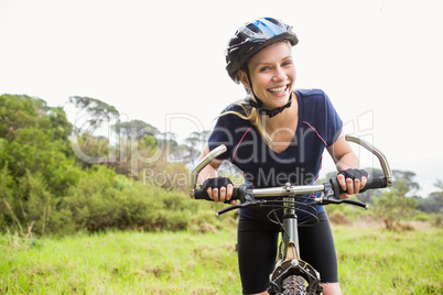 Smiling athletic blonde with mountain bike
