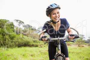 Smiling athletic blonde with mountain bike