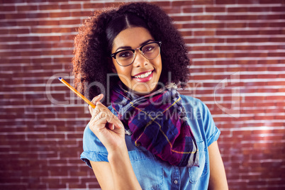 Smiling attractive hipster holding pen