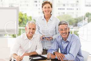 Smiling business people looking at camera