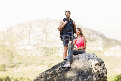 Young happy joggers standing on rock