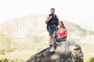 Young happy joggers standing on rock