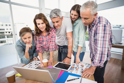 Casual business team having a meeting using laptop