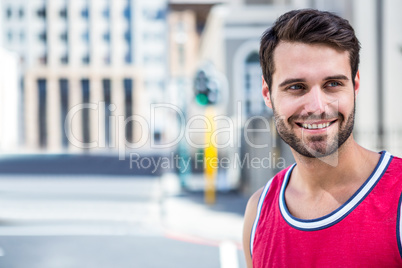 Smiling handsome athlete looking away