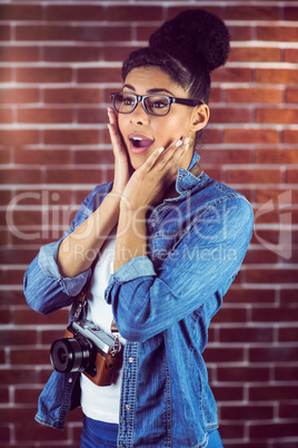 Portrait of a hipster surprised with her camera