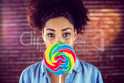 A beautiful woman holding a giant lollipop