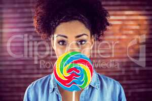 A beautiful woman holding a giant lollipop