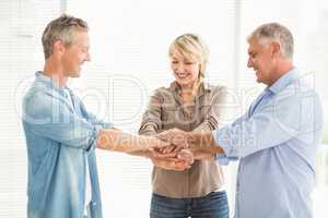 Smiling business colleagues stacking hands