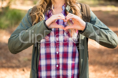 Blonde hiker framing heart with hands