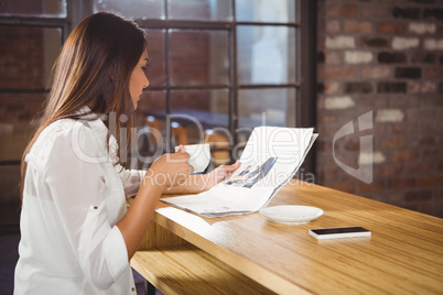 Casual businesswoman looking at files