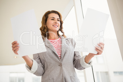 Casual businesswoman holding papers