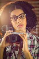 Attractive hipster holding camera
