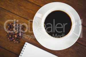 Close up view of cup of coffee and notepad