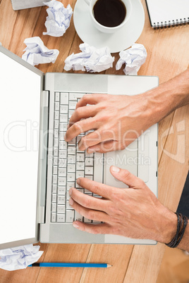 Hands typing on blank screen laptop