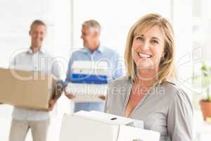 Smiling casual businesswoman with carton