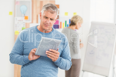 Serious businessman using a digital tablet