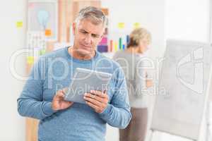 Serious businessman using a digital tablet
