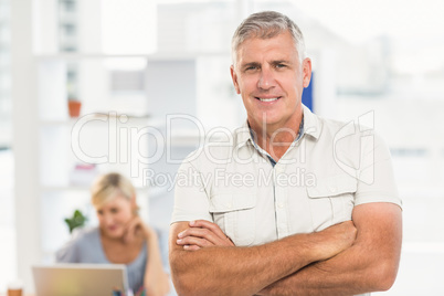 Smiling businessman with arms crossed