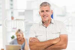 Smiling businessman with arms crossed