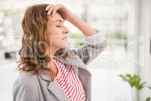 Overworked casual businesswoman having a headache