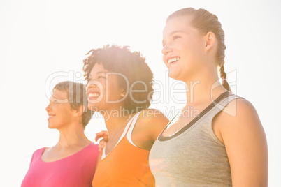 Smiling sporty women looking far away