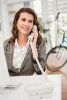 Smiling casual businesswoman phoning