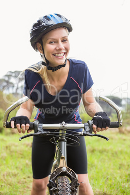 Smiling athletic blonde with mountain bike