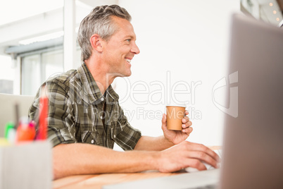 Casual businessman working and having coffee