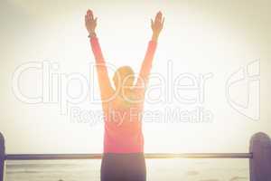 Carefree sporty woman with outstretched arms