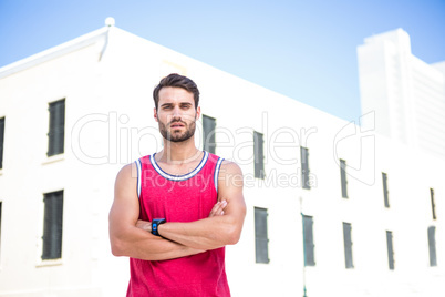 Concentrated athlete with arms folded