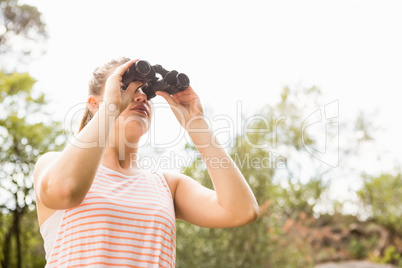 Pretty blonde looking through binoculars