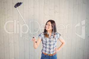 Pretty hipster taking a selfie with stick