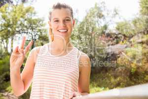 Pretty blonde showing peace sign and taking selfies