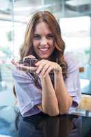 Pretty brunette holding a cupcake