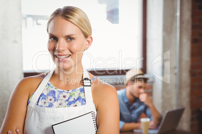 Smiling blonde waitress posing in front of customer