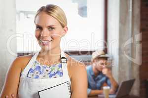 Smiling blonde waitress posing in front of customer
