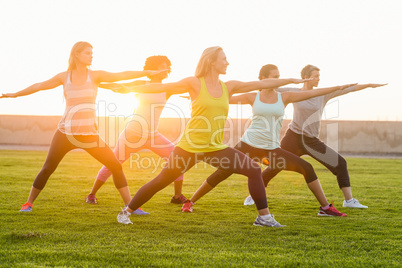 Sporty women warming up during fitness class