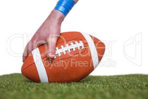 American football player placing the ball