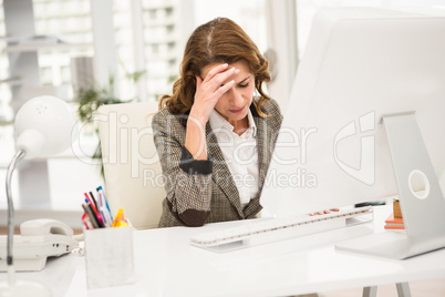 Overworked casual businesswoman working with computer