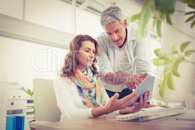 Two casual designers working with tablet