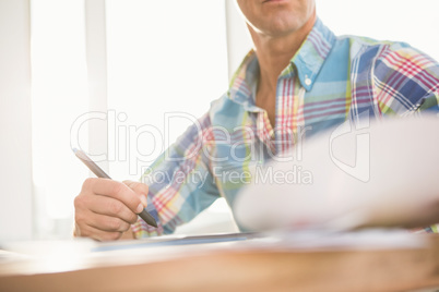 Casual designer working at his desk Casual designer working at his desk