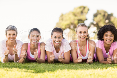 Smiling women lying in a row and wearing pink for breast cancer