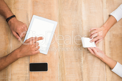 Casual business colleagues using several devices