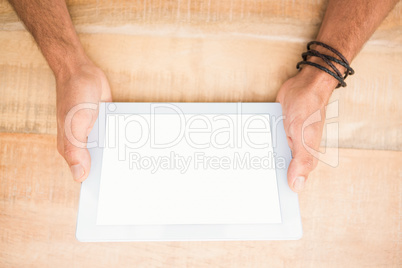 Hands holding blank screen tablet