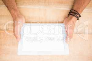 Hands holding blank screen tablet