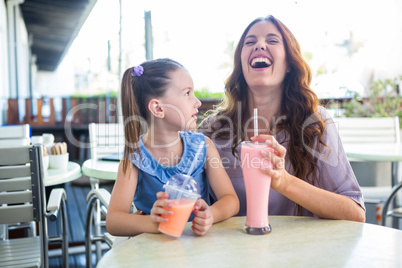 Mother and daughter sitting outside the cafe