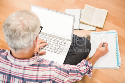 Casual man sitting and working with laptop