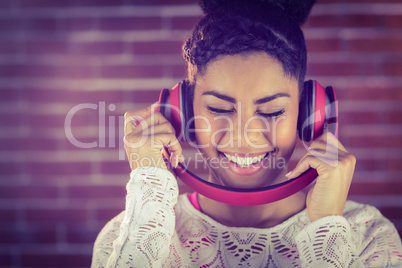 A smiling woman dancing with headphones